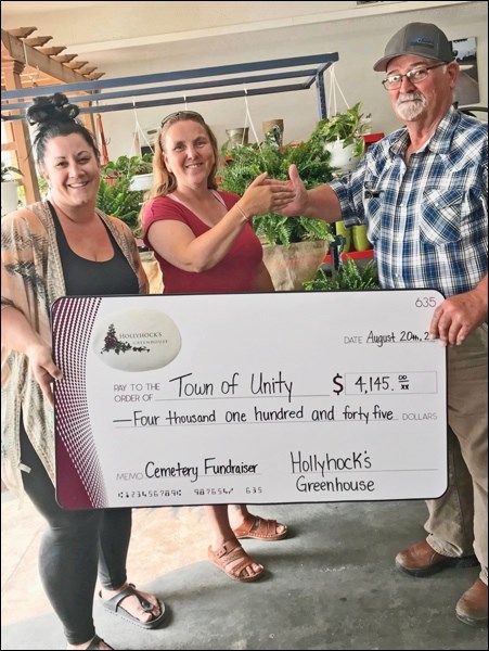 Nicole Headrick, Unity’s Parks and Recreation director, Tammy Lauinger, Hollyhock’s Greenhouse, and Butch Boskill, cemetery fundraising organizer, proudly stand with the presentation from the Hollyhock’s fundraiser which generated more than $4,000 for the sign fundraiser for signage at Pleasant View cemetery. Photo submitted.