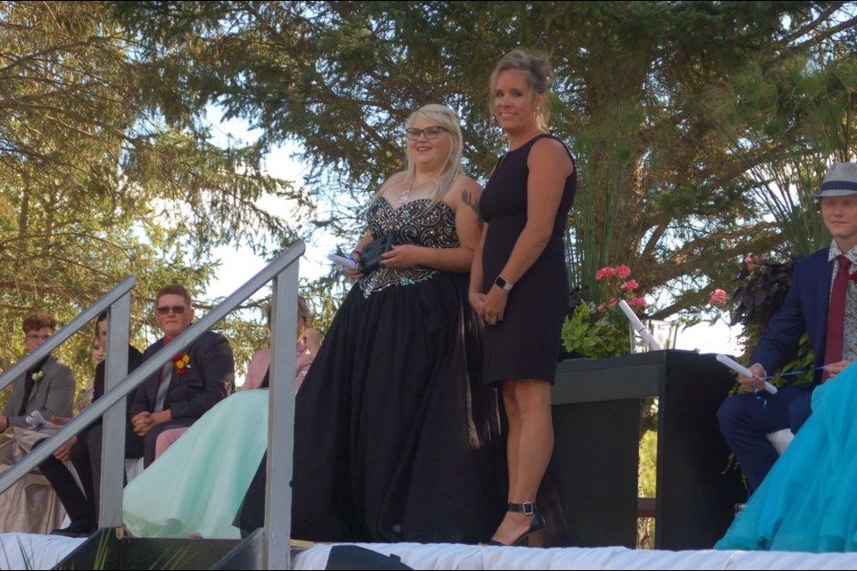 Kacie Meroniuk, left, received an academic award from Kristen Peterson at the Sturgis Composite School graduation ceremony on August 28.