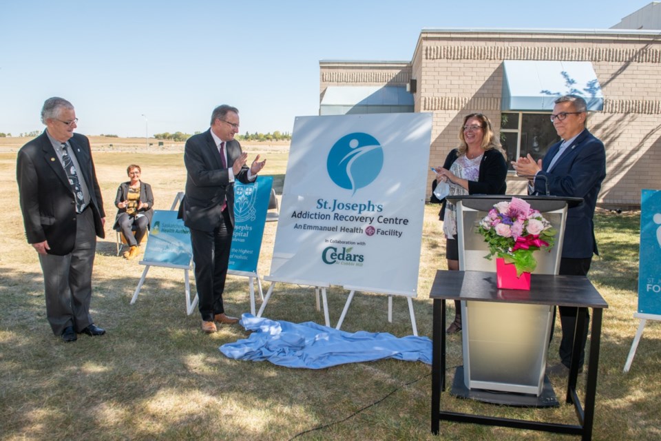 From left, St. Joseph’s Hospital board chair Don Kindopp, Minister of Health Jim Reiter, Estevan MLA and Minster of Government Relations Lori Carr, and St. Joseph’s Hospital CEO Greg Hoffort unveil the sign for the new St. Joseph’s Addiction Recovery Centre. The flowers were sent by Sister Therese Roddy and the Sisters of St. Joseph. Photo by Brian Zinchuk