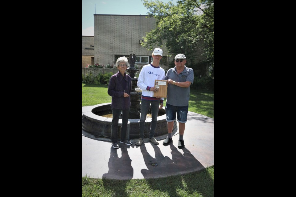 Todd Pankratz of Preeceville received the Marlin Romaniuk Memorial Top Scorer award and the Jack Prien Top Forward award. Photographed from left, were: Cynthia Romaniuk (sponsor), Pankratz and Rudy Romaniuk (sponsor).