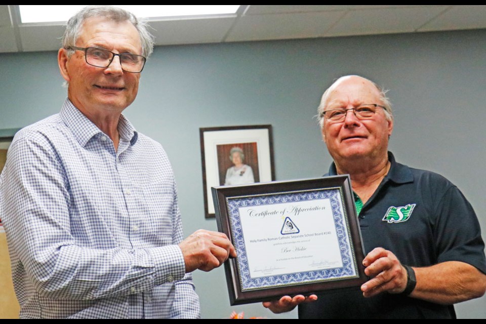 Retiring Estevan trustee Bev Hickie accepts a certificate from Bruno Tuchscherer, the board chair for the Holy Family Roman Catholic Separate School Division. Photo by Greg Nikkel of the Weyburn Review