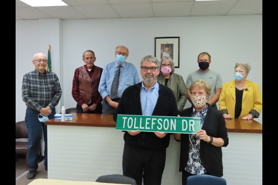 Laurie and Chris Tollefson (front) display the new sign for Tollefson Drive, joined by Outlook mayor Ross Derdall and councillors David Simonson, Floyd Childerhose, Donna Smith, Kyle McLeod, and Maureen Applin.