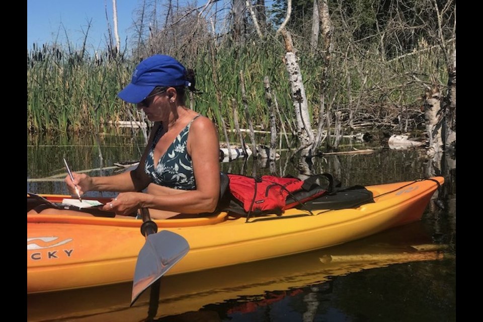 The artist often travels out across Madge Lake on her kayak looking for inspiration.