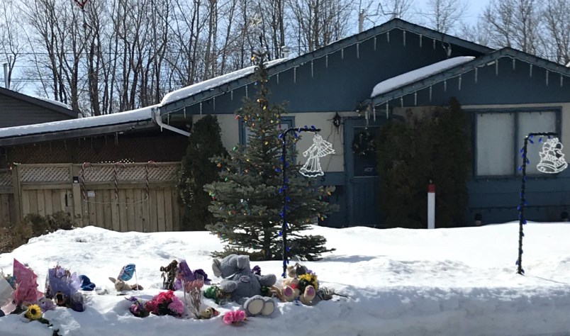 Teddy bears, notes and flowers adorn the front yard of a Prince Albert home where two adults and a boy were brutally murdered and a little girl left for dead. Photograph By LISA JOY
