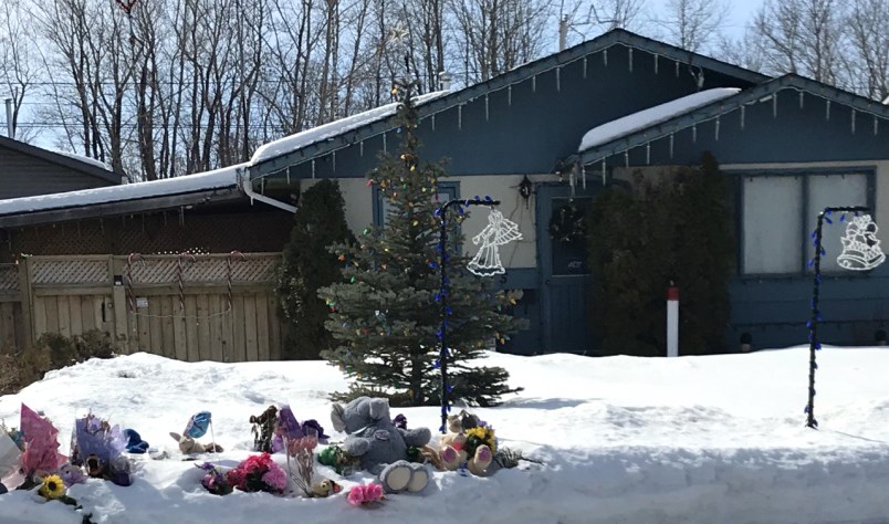 Teddy bears, notes and flowers adorn the front yard of a Prince Albert home where two adults and a boy were brutally murdered and a little girl left for dead. Photograph By LISA JOY