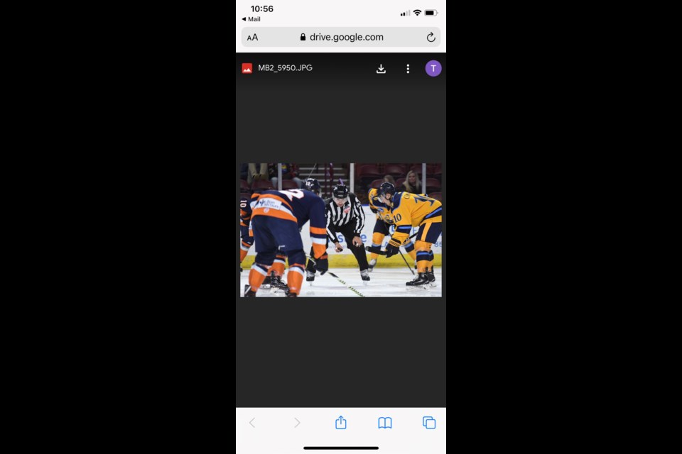 Tarrington Wyonzek dropped the puck for a faceoff during an ECHL game between the Atlanta Gladiators (light jersey) and the Swamp Rabbits in Greenville on December 11, 2019.