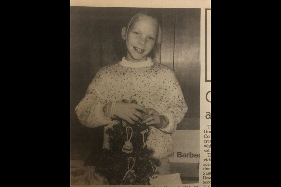 December 20, 1990- Heather Tunbridge of Sturgis adjusted an ornament on a miniature Christmas tree at the Sturgis and District Farmers Market.