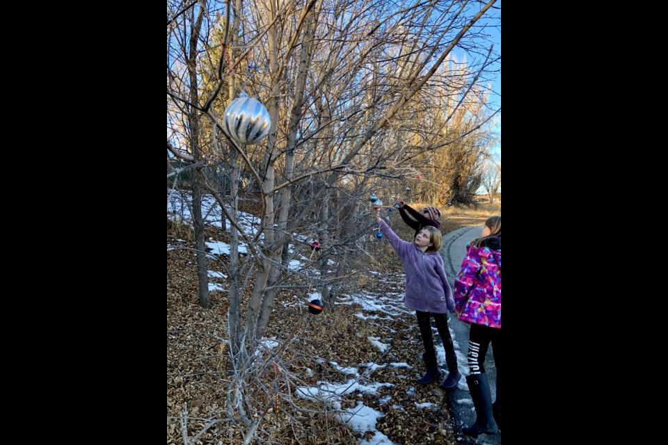 Brynn Hubick, Quinn O’Hanlon and Tucker Karcha spent an afternoon adding Christmas decorations to trees. Photo submitted.