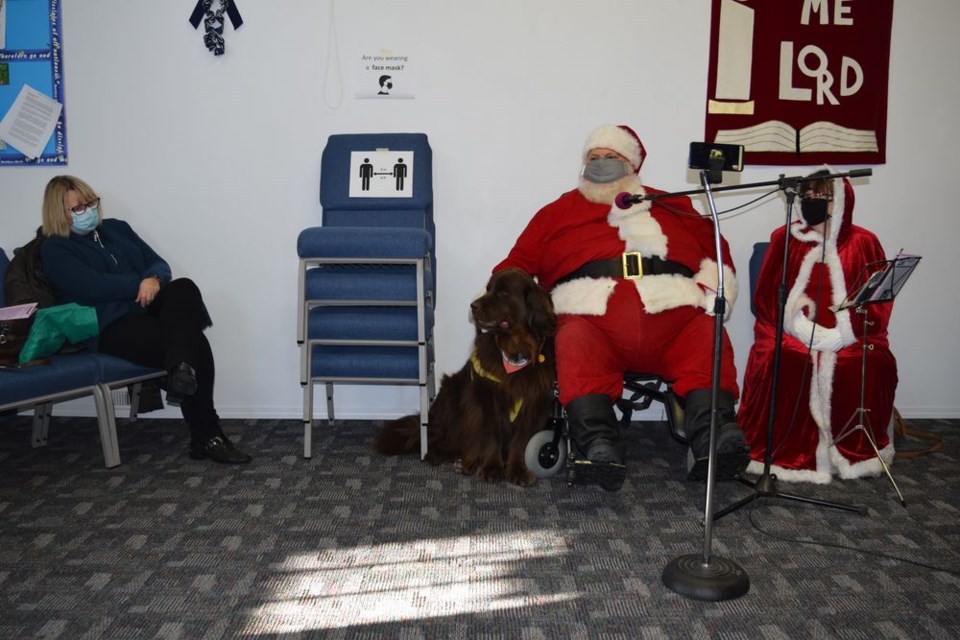 Dressed as Santa Claus, accompanied by his wife BettyAnn (Mrs. Claus) and helper dog Briar-Rose, James Regehr presented his sermon God’s Greatest Gift, sharing the message of “Peace on Earth, good will to all” at Gateway Community Church in Canora on December 6, with social distancing.