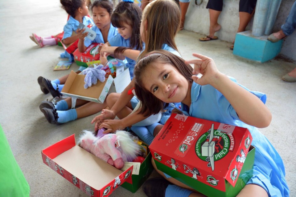 Children in Costa Rica and Senegal checking out their Canadian-packed Operation Christmas Child shoe