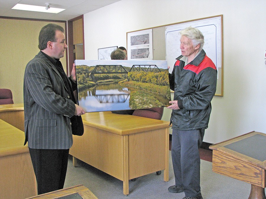 In 2008, photographer Menno Fieguth of Battleford (right) delivering a photo to then Mayor Chris Odi