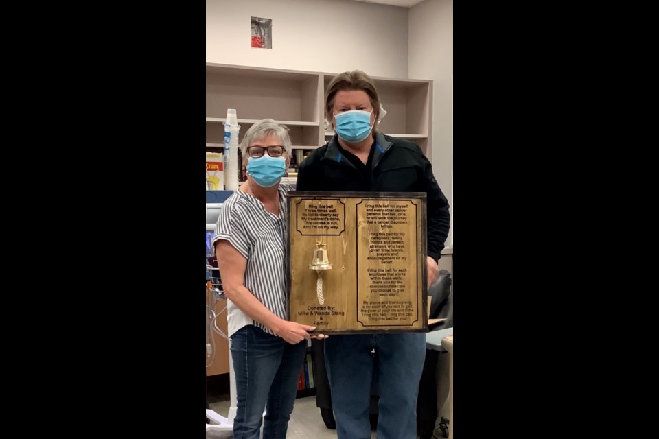 Wanda Stang and her husband Mike with the bell and plaque that they donated to the chemotherapy ward at St. Joseph’s Hospital. Photo submitted