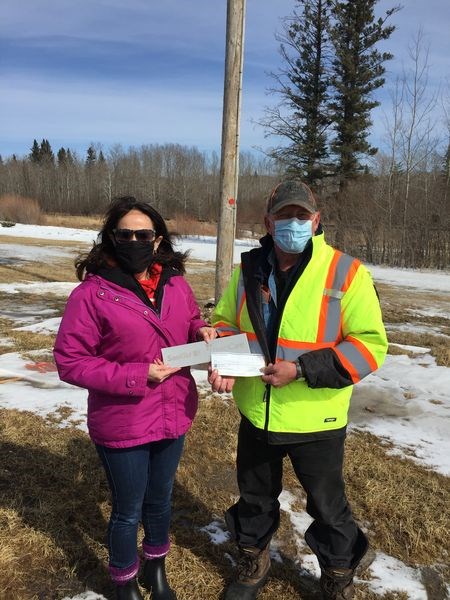 Michelle Englot, left, representative from Sasktel, also made a special donation of $800 towards the Osprey relocation project in the Village of Endeavour. Mayor Brad Romanchuk accepted the donation.