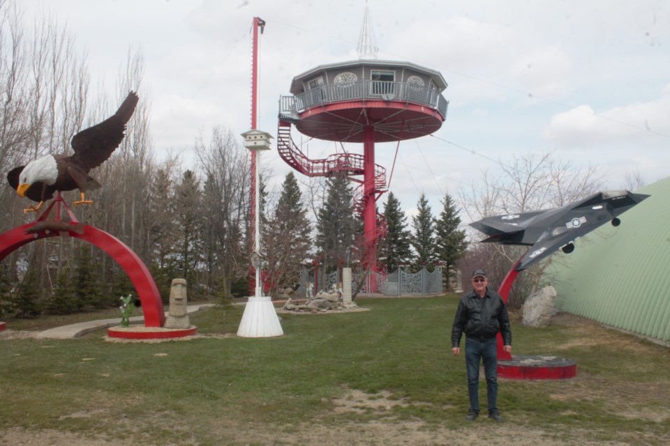 Wilfred Moellenbeck poses next to some of his creations including his “penthouse.” Photo by Jessica R. Durling