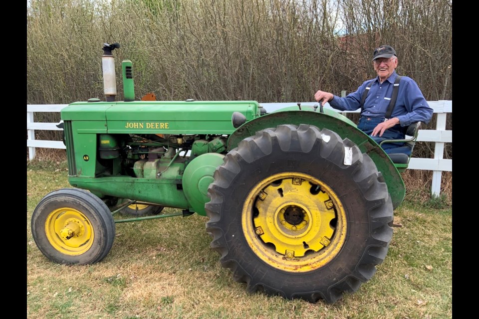 Walter Tait still occasionally fires up a John Deere tractor purchased from John Dart’s store in Meota on May 15, 1951. It was brand new 70 years ago it cost $2,500. Photo submitted