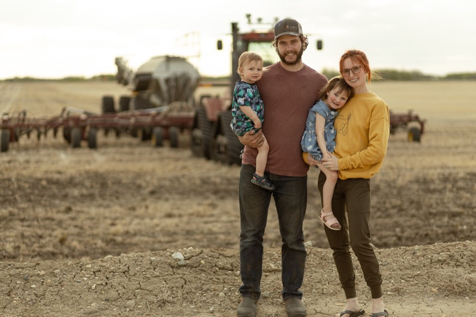 Dylan, Samantha and their children Jack and Haven Breault at the end of another long seeding day. Photo courtesy of SafeHaven Photography