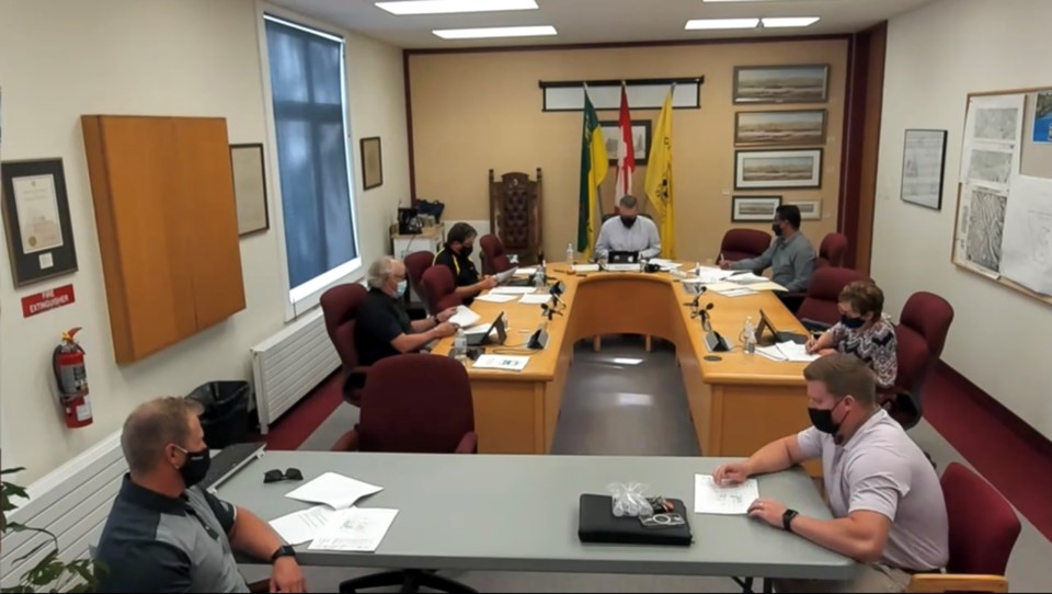 Jay Bottomley, lower right, outlines plans for a new Oil Can Charlie’s location in Battleford to tow