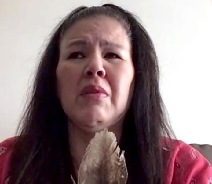 Odelia Quewezance holds an eagle feather during a Zoom call on May 18. Odelia and her sister Nerissa Quewezance were convicted of second-degree murder in 1994. The sisters’ supporters say they are innocent and are calling on the federal government to release them. -Zoom screenshot