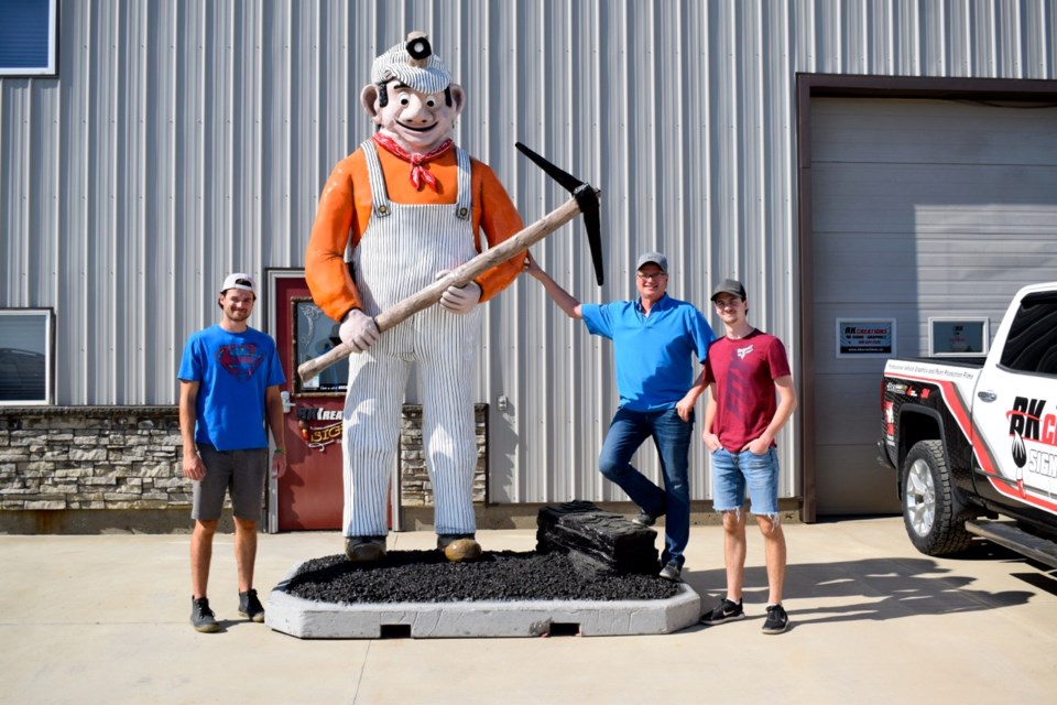 Blane Fichter with BK Creations, along with his sons Jordan, left, and Devin, right, spent over 120 hours refurbishing and fixing Lignite Louie, giving the mascot a new life. Photo by Anastasiia Bykhovskaia