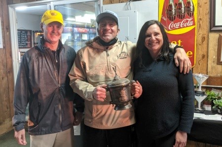 Meota Golf Course Swingers’ Open sponsor Shandon Reichert (left) presenting the Swinger’s Cup to Kyle McNamara and Jade Johnson.