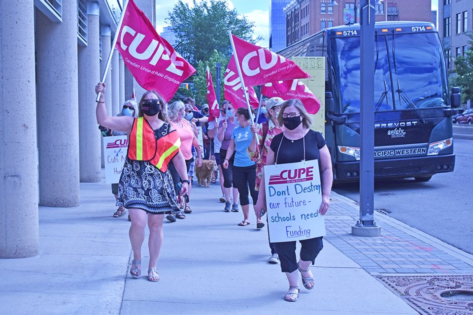 Members and supporters of the Canadian Union of Public Employees march toward the Saskatoon Cabinet office to let officials know what they feel on the $8 million budget cut that the Saskatoon Public Schools division received for the coming academic year in a rally in downtown Saskatoon.