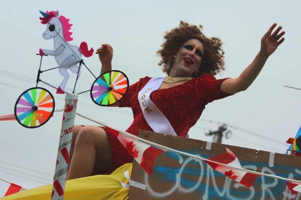 Bijoux waves from atop the Flin Flon Pride float in the 2020 Canada Day Parade. As the inaugural winner of Flin Flon’s Drag Kween Mermaid pageant, Bijoux has taken on a role in growing Flin Flon’s still-nascent drag scene. - FILE PHOTO