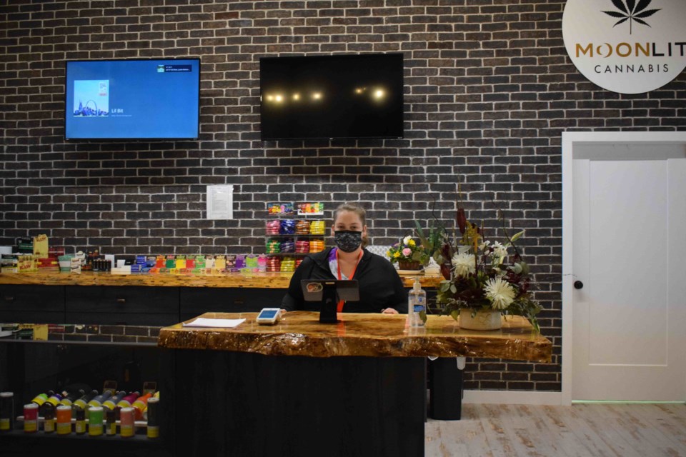Alex More, the salesperson at Moonlit Cannabis, said she really enjoys the modern look of the new store with its stylish rustic accents.