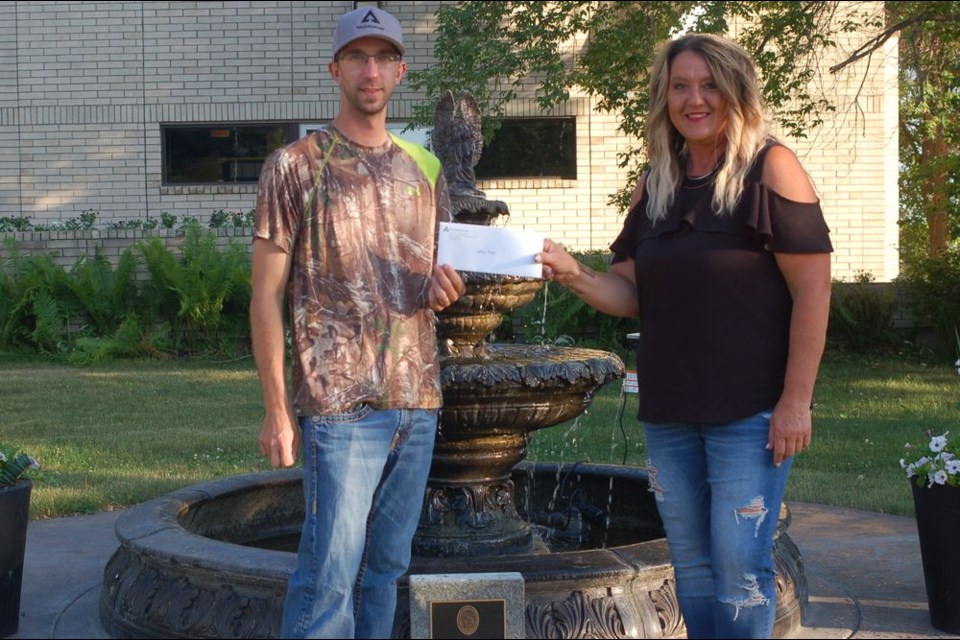 Nathan Draper of Preeceville presented the Preeceville Arena with a cash donation of $1,000 on July 7. The donation was made possible through Weyerhaeuser for his Truck Driver of the Year Award. Draper was given $3,500 to donate to charitable organizations of his choice. The rest of the $2,500 was donated to the Preeceville Volunteer Fire Department. Photographed from left, were: Draper and Andrea Tonn, Town of Preeceville Recreation Director.