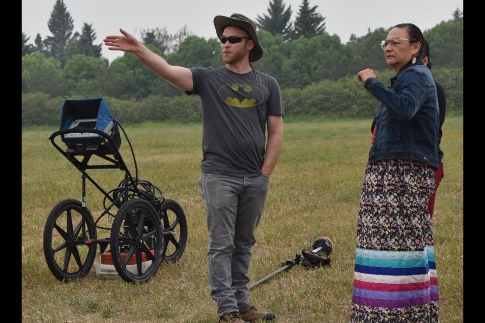 Project lead and Battlefords Agency Tribal Chiefs administration member Karen Whitecalf, right, listens as one of the members of the crews that operate the ground penetrating radar indicates the area they have already scanned and mapped.