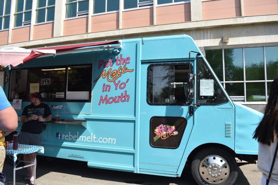 Customers wait for their orders in front of the Rebel Melt food truck on the first day of the Food Truck Wars on Thursday in Downtown Saskatoon.