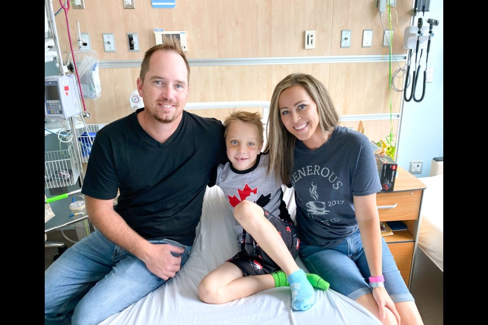 Daniel and Lauren Daae with their seven-year-old son Easton in the Jim Pattison Children’s Hospital in Saskatoon. Easton was injured in a farming accident in early July. Photo submitted