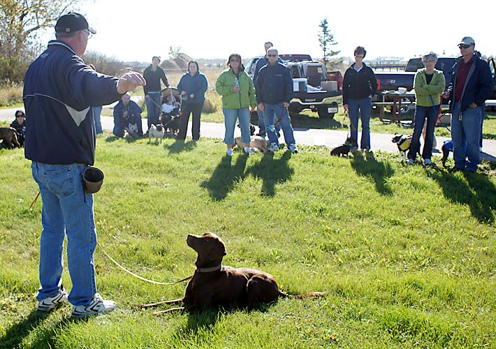Bill Allen and his dog Kaazan demonstrate some basic "Dog Manner" lessons to a group of dog owners at the Dog Park on Oct. 2. The Dog Park committee had offered an open social for interested owners during the afternoon, with the opportunity to learn some obedience training and dog rehabilitation from Allen. The Dog Park is located just south of Aylmer Street, close to the Tatagwa Parkways. It still requires fencing, and committee members are accepting any donations for the establishment of a lease-free Dog Park.