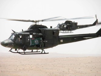 Pilsner Rider flag flown in CH-146 Griffon helicopter, piloted by Captain Ian Bonnell (Regina) and flag held by Door Gunner Sergeant Chad Zopf (Regina), during the mission in Kandahar, Afghanistan.