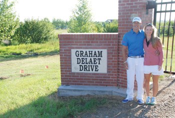 Graham DeLaet posed with his wife Ruby on July 27 at the gates of "Graham DeLaet Drive" on the way to the Weyburn Golf Club for the inaugural charitable tournament also named after DeLaet.