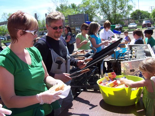 (L-R) Rochelle Wendt of the Souris School Community Council and Souris School principal Lars Guenther served up hot dogs to students and their families on May 21 as part of the 100th birthday celebration.