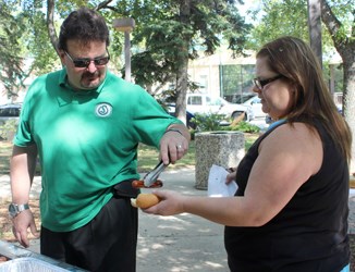 The Weyburn United Way kicked off the 2014 Communithon festivities on September 5 at Memorial Park with a barbeque. United Way board member Brett Cooper served up a hot dog to Tasha Collins, of the Canadian Mental Health Association. The CMHA is one of the member agencies that benefits from the Communithon.