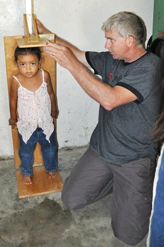Lowell Pederson measured a Honduran child to help the people record basic medical information such as height, weight, age and name.
