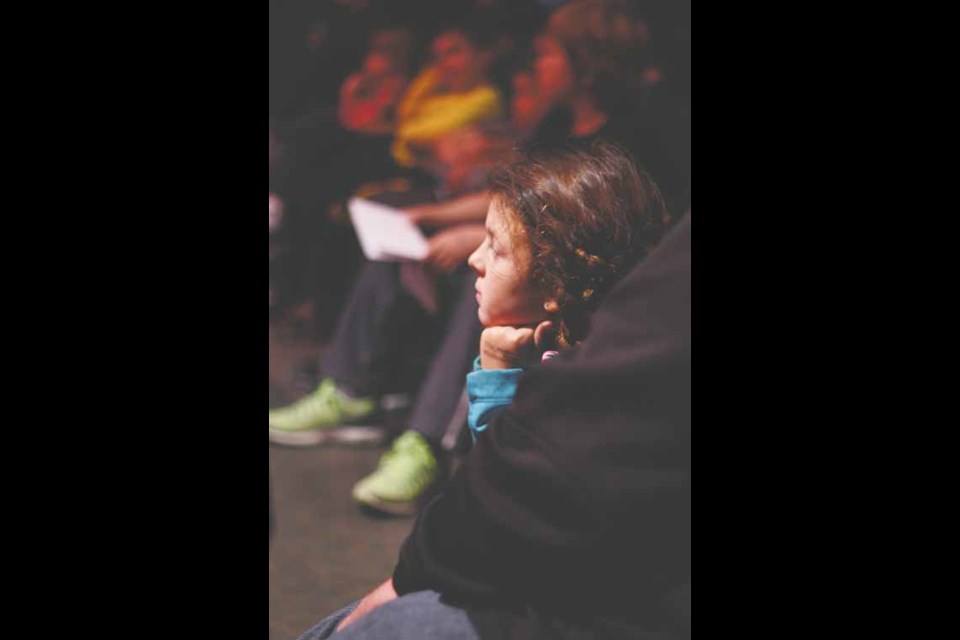 Children in the audience paid rapt attention to the magician.