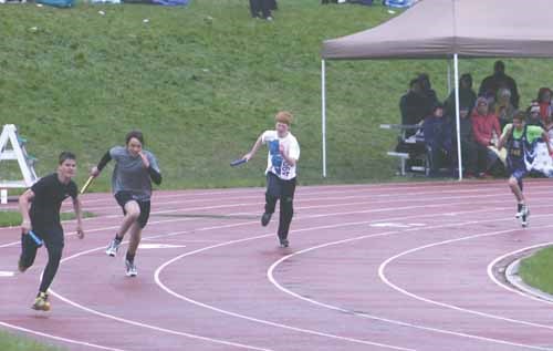 Cole Burkholder, left, has an edge over his competitors during Thursday morning's relays.