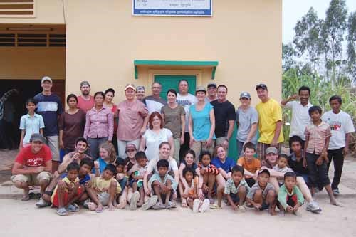 Volunteers, staff and residents pose in front of the freshly painted orphanage. Back from left: Des Klingspon, Om Phorn, Ben Swan, Sun Korliyan, Marlene Swan, Tyra Niebergall, Sherry Grunert, Craig Grunert, Andrea Thomson (kneeling), Raelene Prieb, Bryon Prieb, Renae Miller, Rock Beaton, Rich Prieb, Donna Pelchat, Mario Pelchat, Em Socheat, Sam Tolle (FCOPI), Andriy Kavchuk, Gabrielle Thomson, Bailey Pelchat, Caleigh Grunert, Janaye Prieb, Paige Swan, Avery Prieb, Caleb Swan.