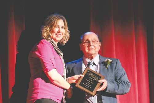 Gymnastics athlete/builder Mike Matich, right, accepts his induction plaque.