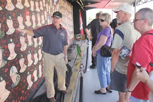 Volunteer Gord Trecartin guides visitors through some of the faces on the mural during its stop in Yorkton.
