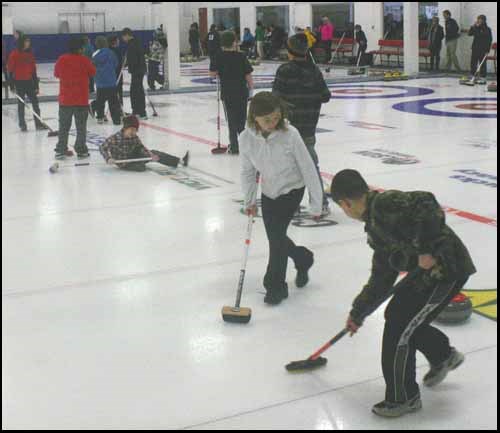 Stephanie Flaman watches as teammate Reese Kinaschuk sweeps.