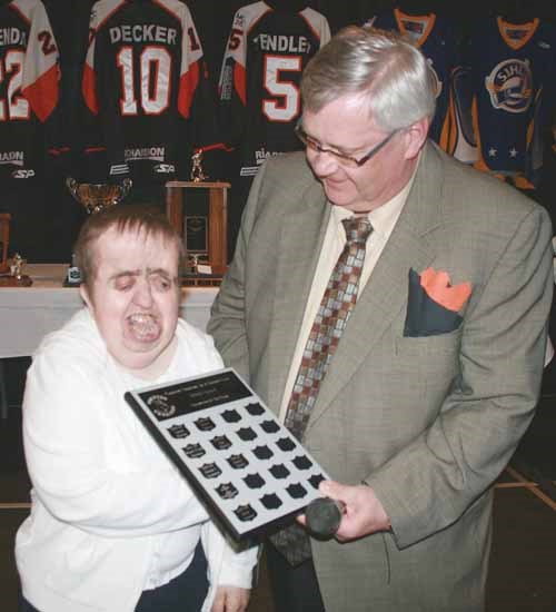 Donna Moore was presented with the team's Volunteer of the Year award from president Lyle Walsh.