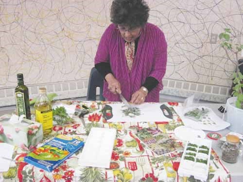 Bilkies McKen, prepares a hands-on demonstration with audience participation, on preserving hard leaf herbs as opposed to tender leave herbs.