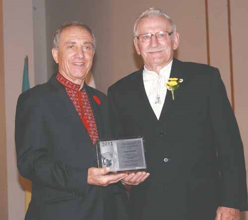 Ukrainian Canadian Congress - Saskatchewan Provincial Council president, Slawko Kindrachuk, left, presents a Nation Builder Award to Taras Korol.