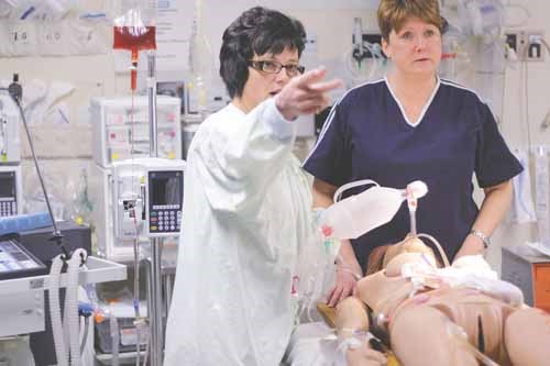 ER nurses Koliann Schwaga (L) and Karen Tratch demonstrate trauma room procedures.