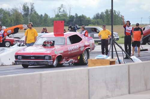 One of the infamous alcohol-fueled funny cars lines up for a high speed race.