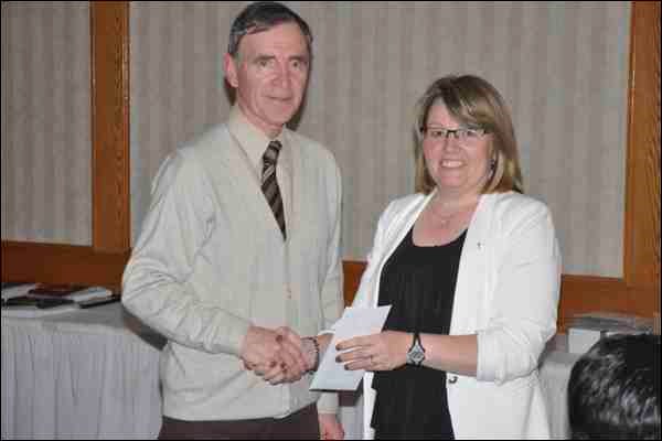 Eugene Rice is presented a 30-year Service Award from  Stephanie Merkowsky.