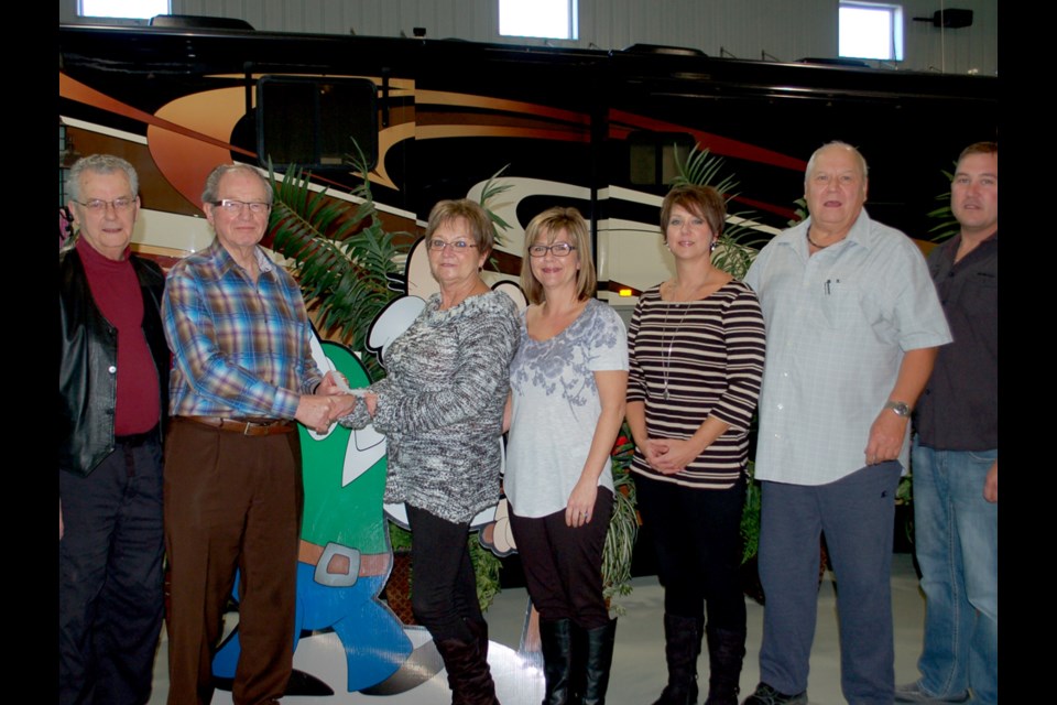 Gloria Trobert handed a $100,000 cheque to Hearthstone committee representatives Vern Buck and Don Kindopp (left), while other Trobert family members looked on. Beside Gloria is Teresa Benning, Jody McKersie, Joe Trobert and Kevin Trobert.